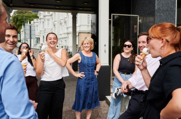 Some of our team stand around at the seaside in Brighton, enjoying ice creams.